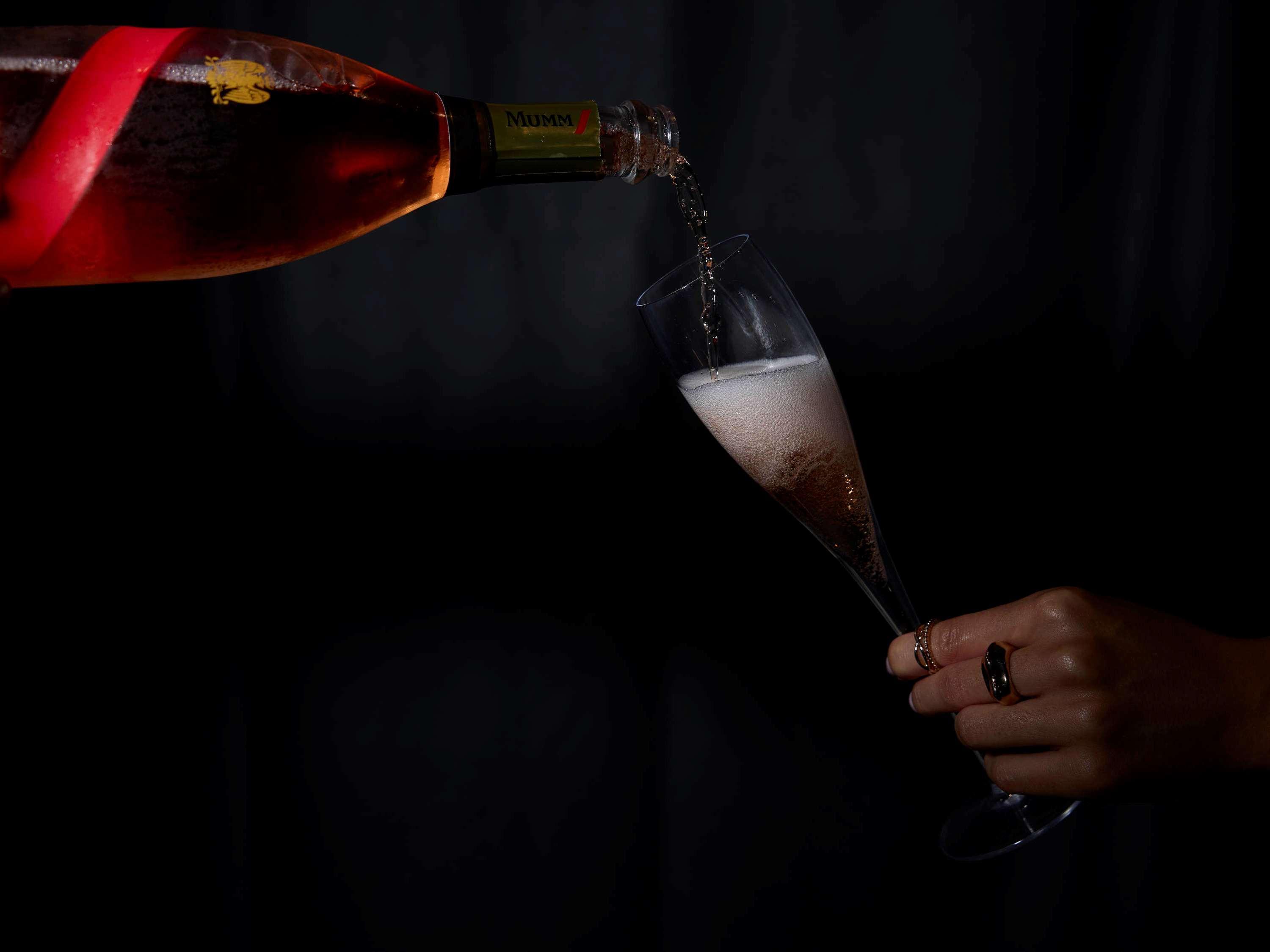 Movenpick Hotel Auckland Exterior photo A bottle of champagne being poured into a glass