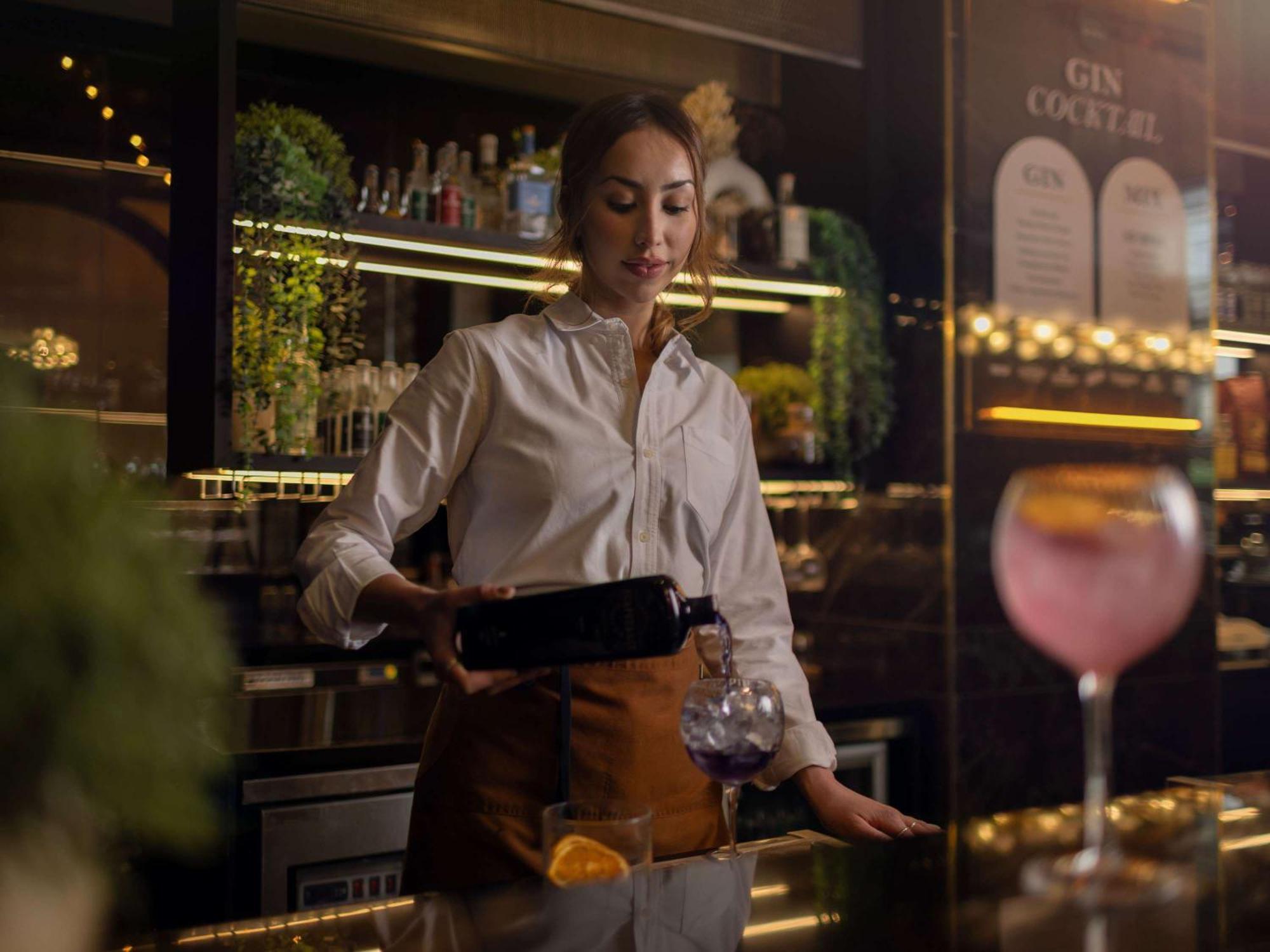 Movenpick Hotel Auckland Exterior photo A bartender at work