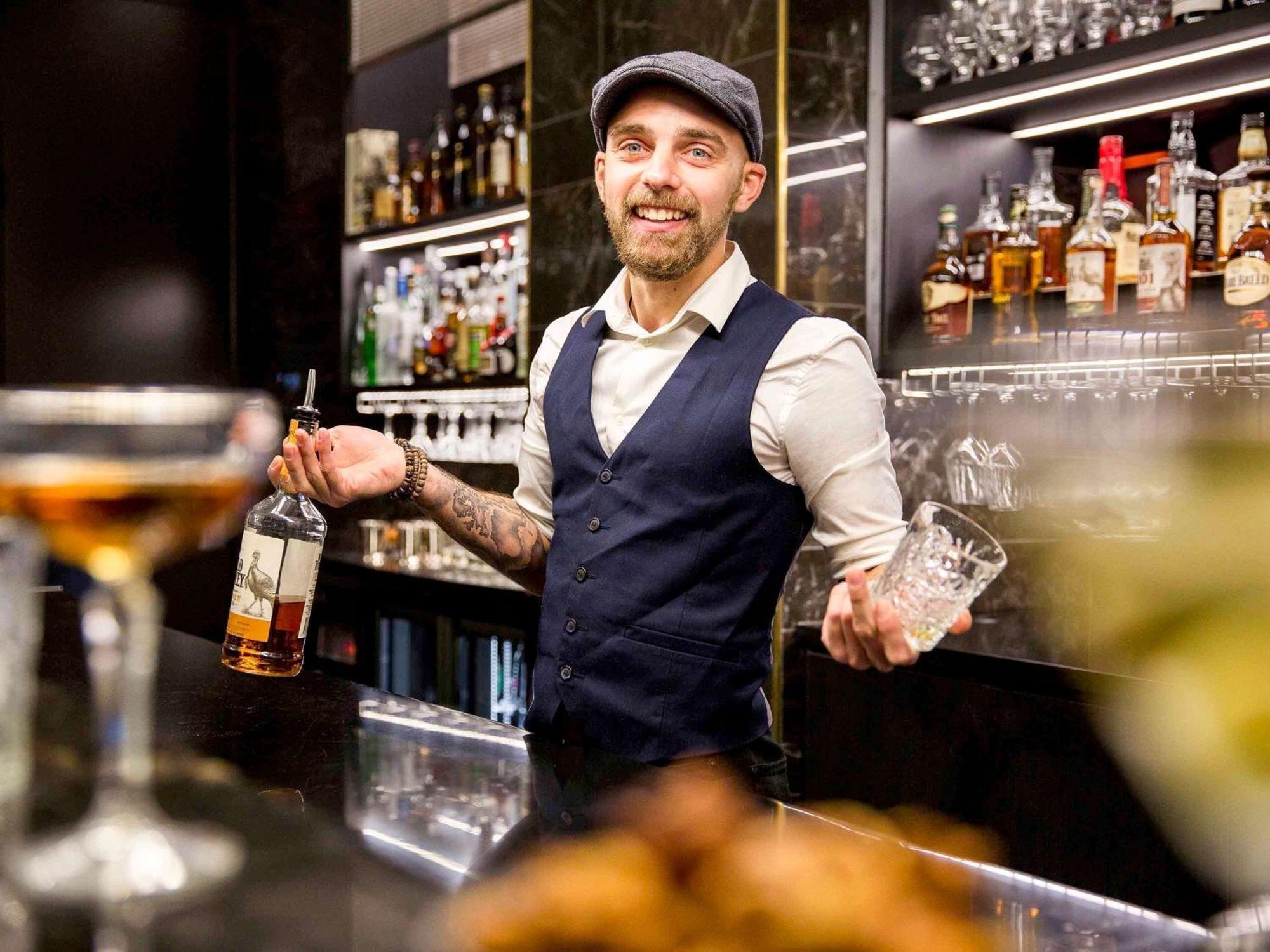 Movenpick Hotel Auckland Exterior photo A bartender at work