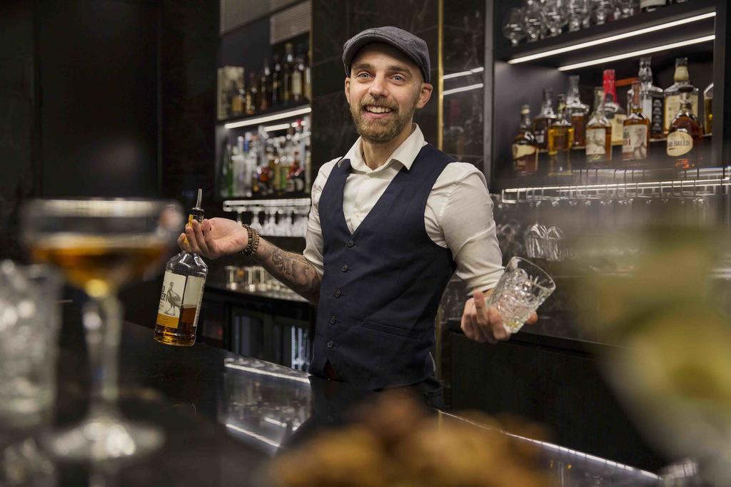 Movenpick Hotel Auckland Exterior photo A bartender at work